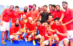 The winning team in a jubilant mood at the Phase IX Hockey Stadium in Mohali on Saturday.