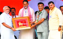 State BJP chief Ram Bilas Sharma (second from left) felicitates PM Narendra Modi in Karnal on Saturday.