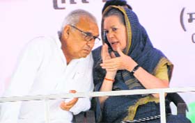 Congress president Sonia Gandhi with CM Bhupinder Singh Hooda at Meham village in Rothak district on Saturday.