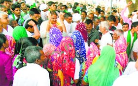 INLD leader Abhay Singh Chautala seeks blessings from elderly women at Rupana Jatan village in Ellenabad.