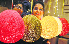 Girls have a look at decorative items at an exhibition in Ludhiana. Photo: Inderjeet Verma