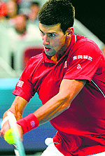 Novak Djokovic returns to Andy Murray during their semifinal at the China Open in Beijing on Saturday