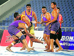Satnam of Vancouver Lions tries to stop Yo Yo Tigers raider Gurpreet Singh during their match in Mohali on Saturday