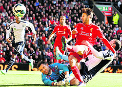 Liverpools Adam Lallana shoots past West Bromwich Albions Ben Foster and Craig Gardner during their English Premier League match in Liverpool on Saturday