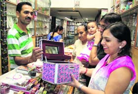 Buzz in markets: A woman purchases a gift item as part of the festivities in Bathinda on Sunday evening.