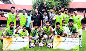 Team members flash the victory sign at the Sector 42 football academy in Chandigarh on Sunday. 