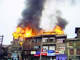 Houses on fire in the Nawakadal area of Srinagar on Saturday. 