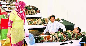Army personnel donate blood for flood victims at a camp in the J&K Light Infantry Regiment headquarters on the outskirts of Srinagar on Saturday. 