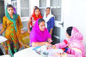Dr Shaminder Bhangu examines a volunteer during a medical camp at Tamkaudi village on Sunday.