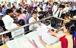 Applicants submit forms during the 21st Aryans Job Fest at the Aryans Group of Colleges in Ludhiana.