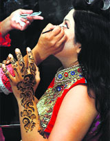 A woman gets ready during an event in Ludhiana.