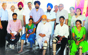 Members of the Bharat Vikas Parishad Charitable Trust with the physically challenged in Ludhiana.