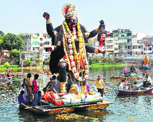 Devotees immerse an idol of Goddess Kali in a lake after the conclusion of Navratri festival in Bhopal on Sunday.