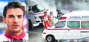 Marshalls clear the way for an ambulance after the race was stopped following a crash by Marussia driver Jules Bianchi (above). The Frenchman was taken to hospital after being seriously injured in a crash that brought a wet Japanese Formula One Grand Prix to halt on Sunday.