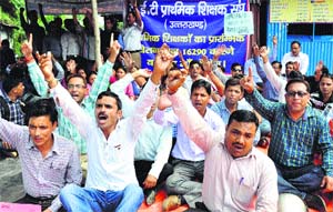 TET primary teachers protest at Parade Ground in Dehradun on Sunday.
