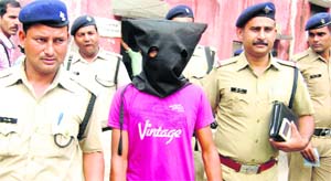 Policemen with the accused of the Nakronda robbery case at the SP city office in Dehradun on Sunday