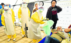 Volunteers train at a Doctors Without Borders (MSF) replica of Ebola treatment centres in Brussels.