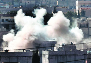 Smoke rises from a building of Ain al-Ara.