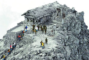 Rescuers arrive to conduct search operations at the ash-covered Ontake Shrine near the summit of Mount Ontake in Japan.