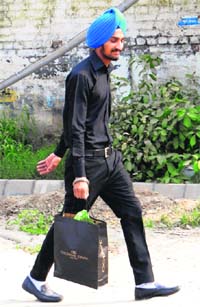A youth carries a cardboard bag in Amritsar.