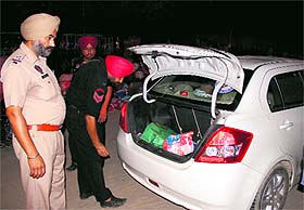 Policemen check a vehicle at Ghanaiya Chowk in Bathinda on Monday.