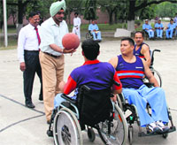 Lt Gen KJ Singh, GOC-in-C, Western Command, with inmates of the Paraplegic Rehabilitation Centre in Mohali on Monday. A Tribune photograph