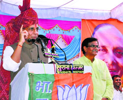 Union Home Minister Rajnath Singh addresses a meeting at Paatauda village in Jhajjar district on Monday.