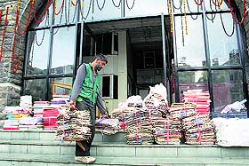 A Kashmiri labourer shifts files of the Municipal Corporation office from Town Hall to the transit accommodation in the Deputy Commissioners office complex in Shimla on Sunday. The shifting will make way for the renovation of the 106-year-old historic Town Hall and conservation of The Mall under the Rs 32-crore project, the foundation for which was laid by Chief Minister Virbhadra Singh. 