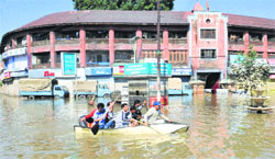 People ride to safety during the floods in Srinagar. Tribune Photo: Amin war