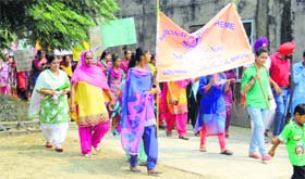 NSS volunteers of Guru Nanak National College, Doraha, take out a rally at Tamkaudi village on Monday.