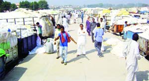 Farmers block traffic as they sit on a dharna on the national highway outside the grain market in Abohar on Monday