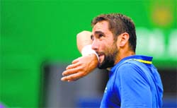 Cilic reacts after a point during their Round 1 match of the Shanghai Masters on Monday