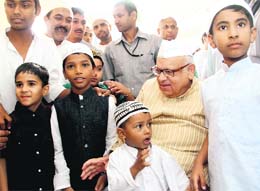 Governor Aziz Qureshi with children after prayers at the EC road mosque on the occasion of Eid-ul-Azha in Dehradun on Monday