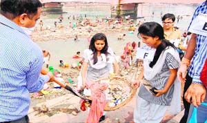 Schoolchildren take part in a cleanliness drive on the banks of the Ganga canal in Haridwar on Monday