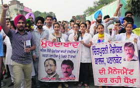Relentless: Students of Chintpurni Medical College along with members of the NSUI take out a candle march at Lawrance Road in Amritsar on Tuesday.
