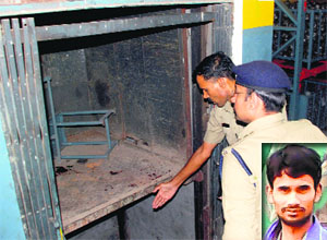 A policeman shows the spot where the victim, Pintu (inset), was crushed to death at a factory in the Industrial Area, Phase I, Panchkula.