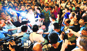 A man who collapsed during the confrontation between anti-Occupy and Pro-democracy protesters being taken away by the police. REUTERS