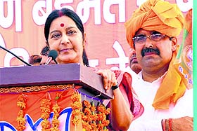 Union External Affair Minister Sushma Swaraj addresses a gathering as BJP candidate Harvinder Kalyan looks on during a rally in Gharaunda on Thursday.