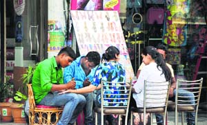 Artists apply henna on the palms of women in Ludhiana