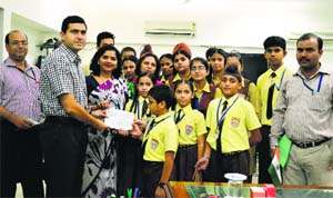 Students and staff of MGM Public School hand over a demand draft for Jammu and Kashmir flood victims to Deputy Commissioner Rajat Aggarwal