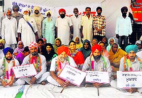 Congress activists protest near the district administrative complex in Fatehgarh Sahib on Tuesday.