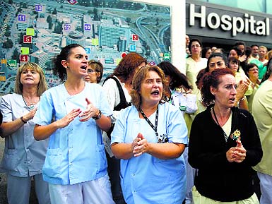 Health workers attend a protest outside La Paz Hospital calling for Spains Health Minister Ana Mato to resign after a Spanish nurse contracted Ebola, in Madrid on Tuesday. 