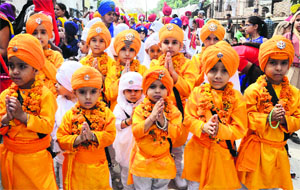 Children participate in nagar kirtan on the occasion of the birth anniversary of Guru Ram Dass in Amritsar on Wednesday.