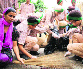 Volunteers of EcoAmritsar clean the route of the Nagar Kirtan taken out on the birth anniversary of Guru Ramdas in Amritsar on Wednesday.