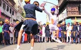 Members of a gatka team perform during a procession to mark the birth anniversary of Guru Ram Das in Bathinda on Wednesday.