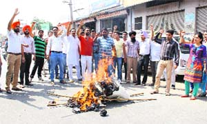 Members of SSA/RMSA teachers union burn an effigy on Wednesday.