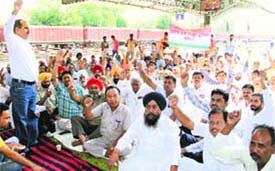 Members of the Uttariya Railway Mazdoor Union protest at the railway station in Bathinda on Wednesday