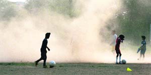 Children run for cover after a dust storm hit Mohali on Wednesday. 
