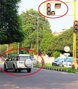 A motorist jumps (encircled) the light on the road dividing Sectors 15 and 16 in Chandigarh on Wednesday