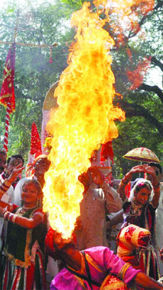 Folk dancers performing their skills during a Shobha Yatra on the occasion of Valmiki Diwas in New Delhi on Wednesday.